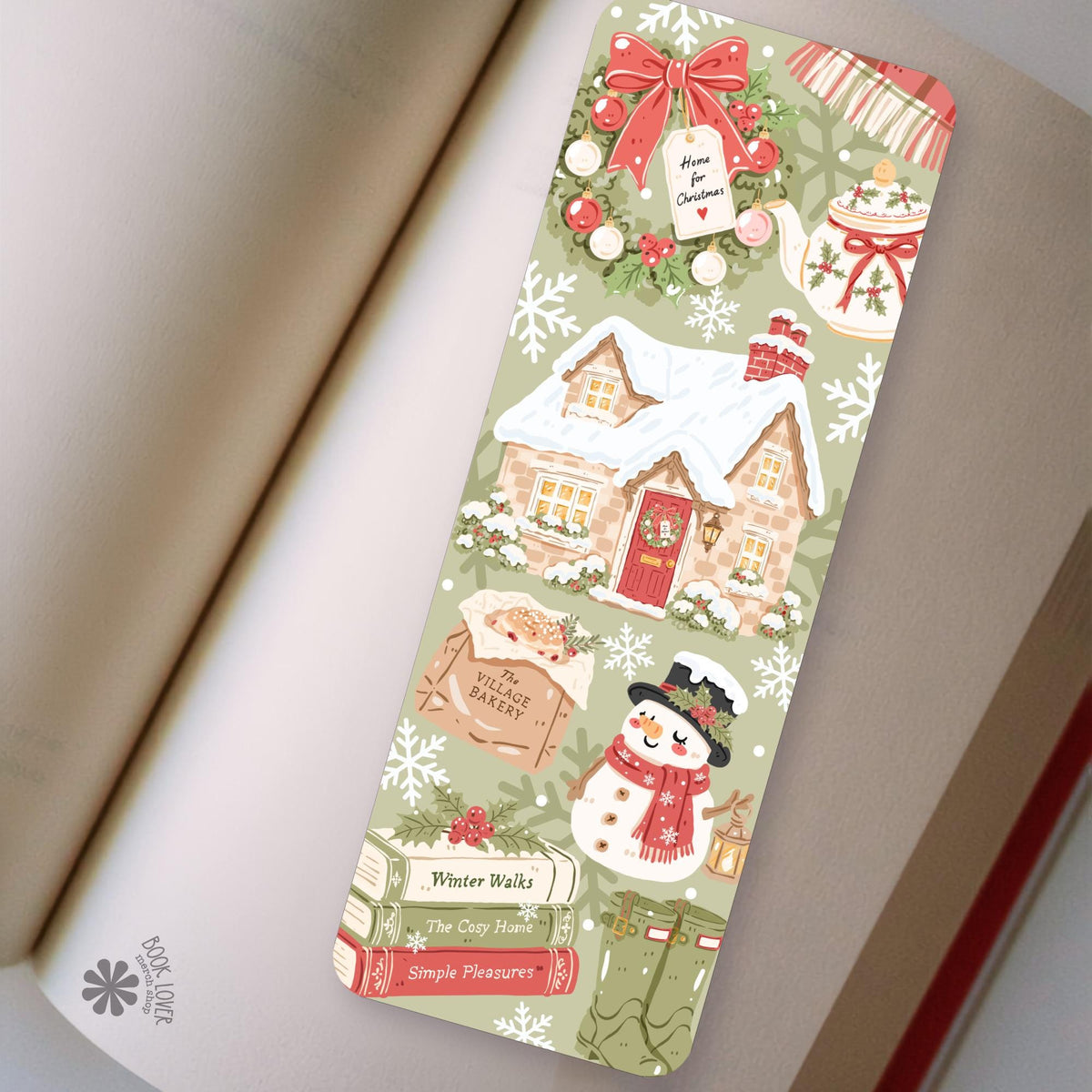 Snowy Village Cottage bookmark in an open book, cozy reading