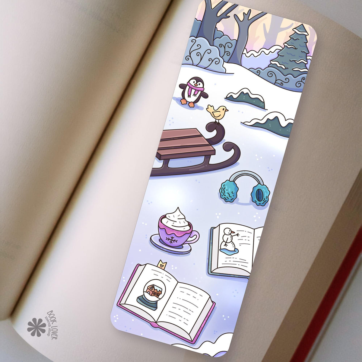 Winter Penguin Sled bookmark in an open book, cozy reading