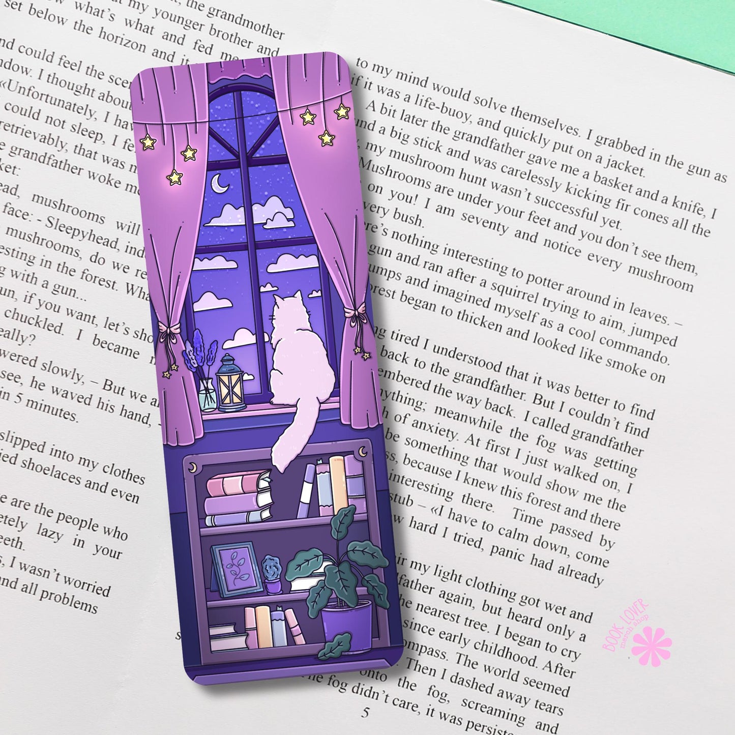 Purple cat bookmark photographed inside an open book